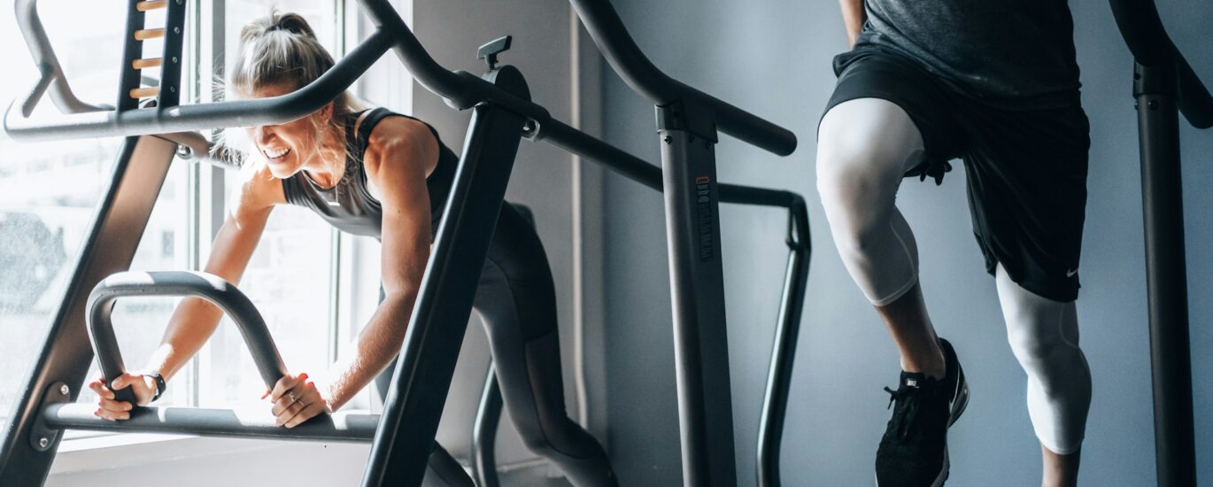 Adults using stair climber machines for cardio fitness