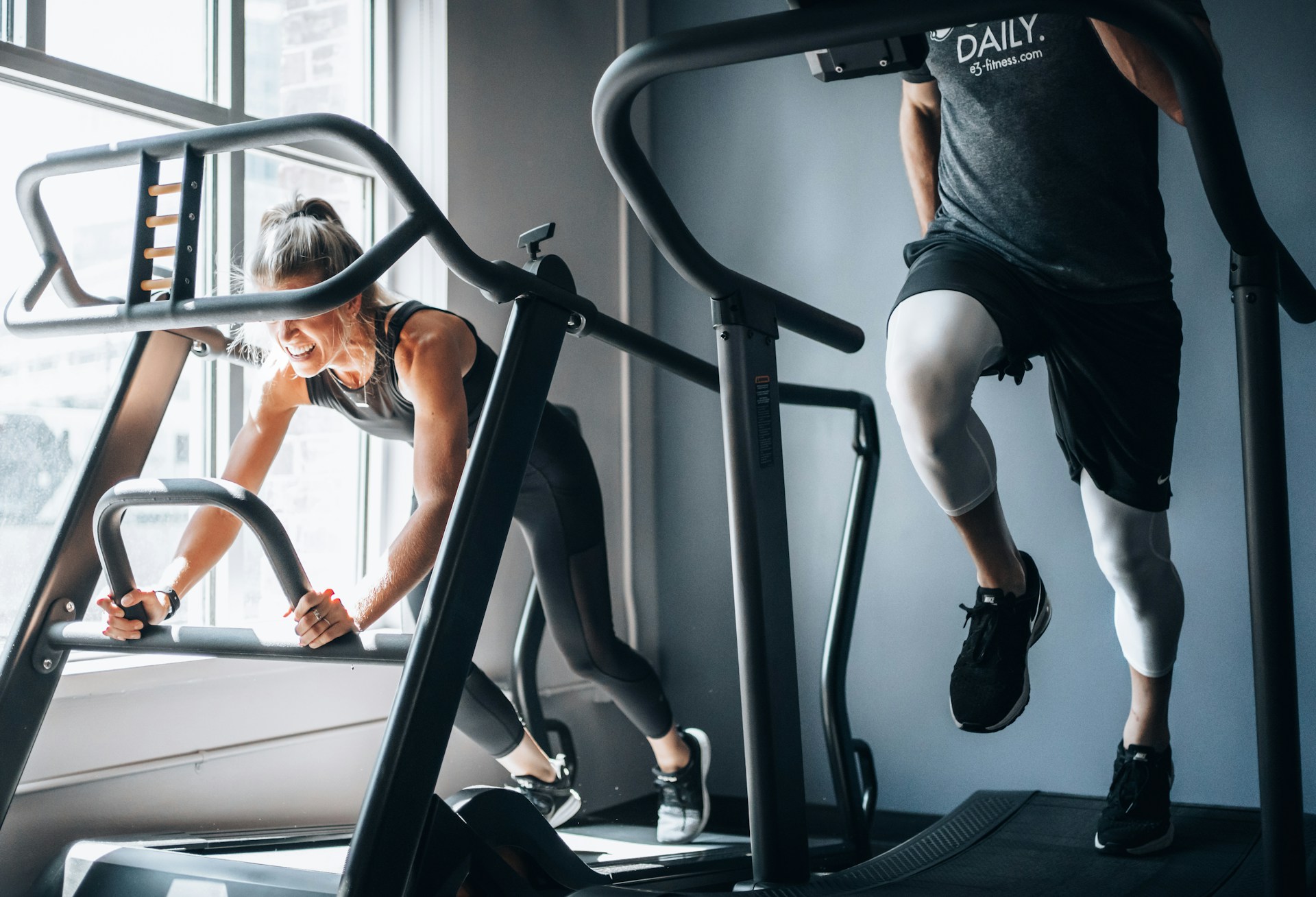 Adults using stair climber machines for cardio fitness