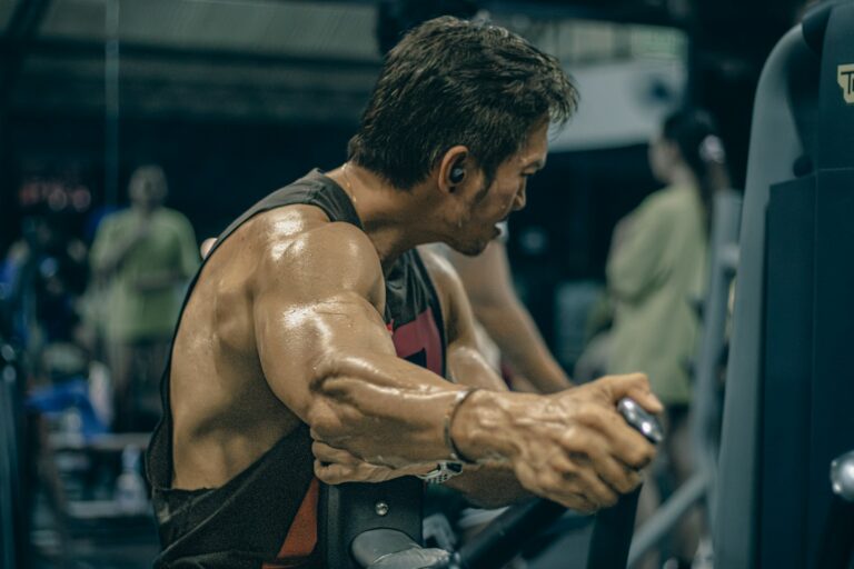 Fit man over 40 performing hsi balanced workout routine on a gym machine