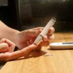Person checking blood sugar for warning signs of insulin resistance