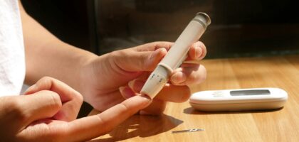 Person checking blood sugar for warning signs of insulin resistance