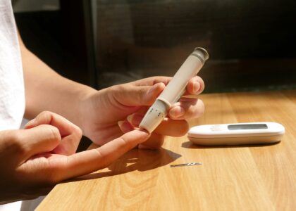 Person checking blood sugar for warning signs of insulin resistance