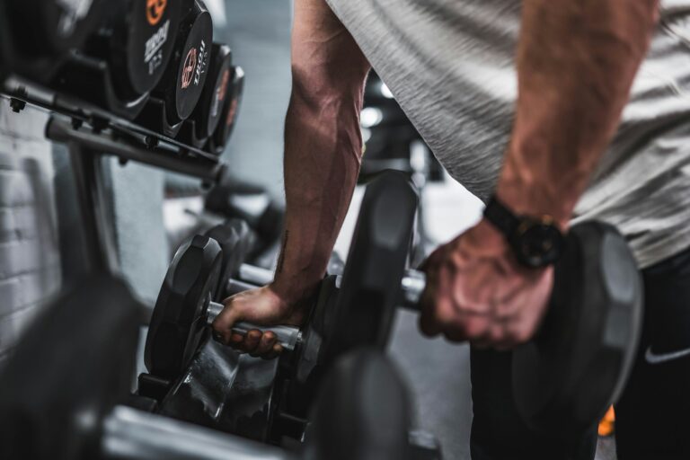 Adjustable dumbbells set on rack for progressive resistance training