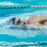 Adult swimmer practicing freestyle lap swimming for longevity in a pool
