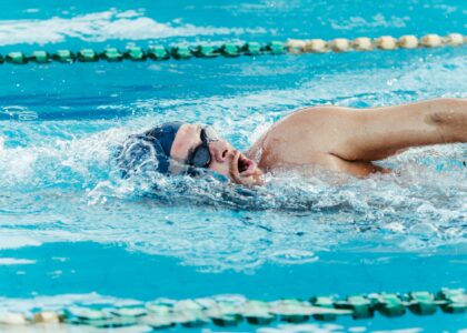 Adult swimmer practicing freestyle lap swimming for longevity in a pool