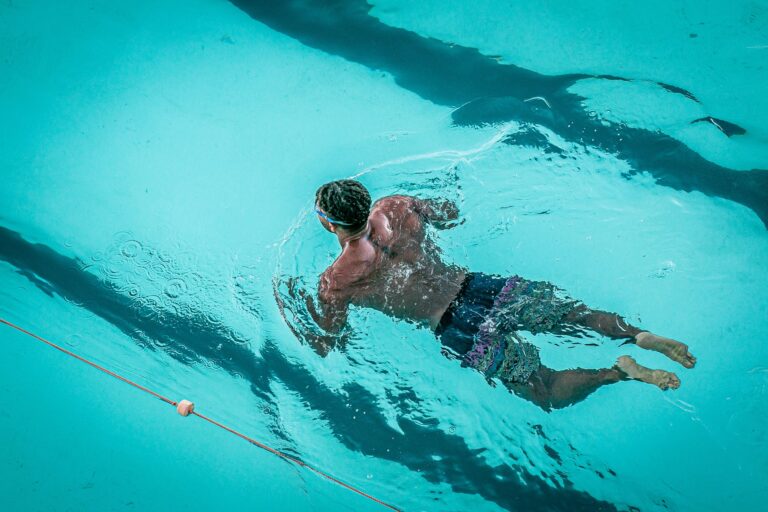 Swimmer floating and engaging core muscles during a low-impact workout for swimming for longevity.